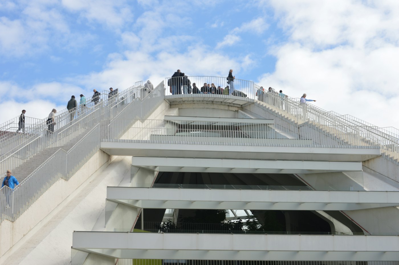 Visitors climbing the external staircases of the renovated white Pyramid of Tirana